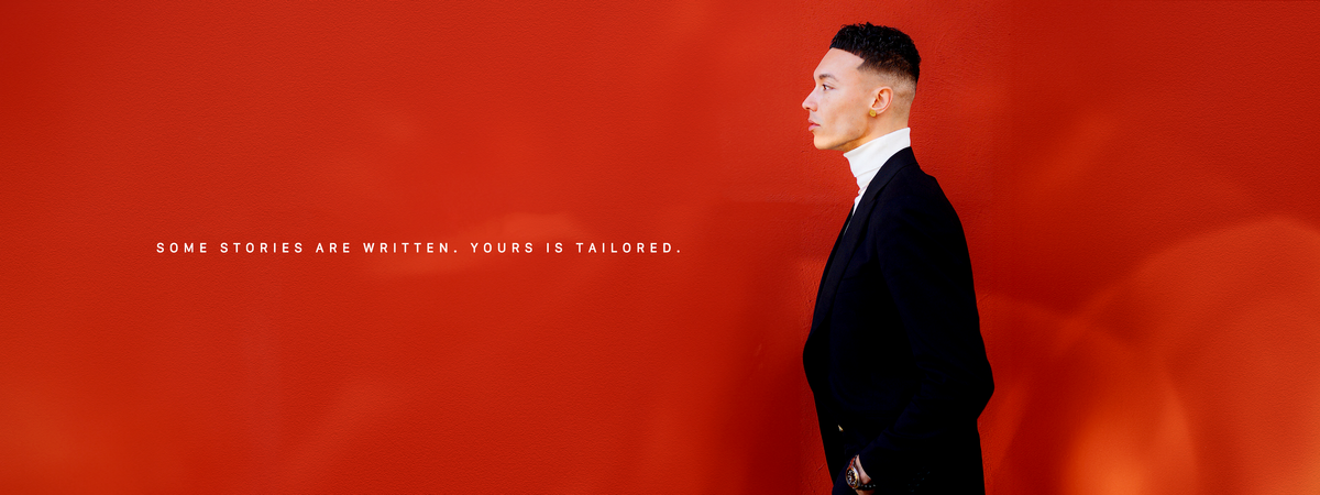 Mac McAdam in an all black woolen Tailored suit by Genaio.